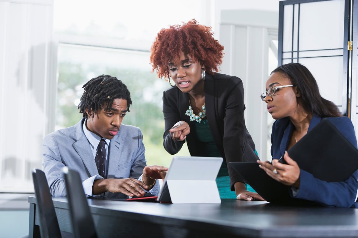 Team of Three Young Businesspeople Working Together